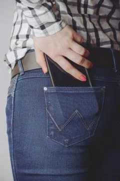 Smartphone in the pocket of jeans Stock Photos