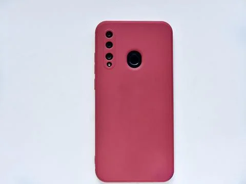 A smartphone in a red case on the back side. Phone camera. Stock Photos