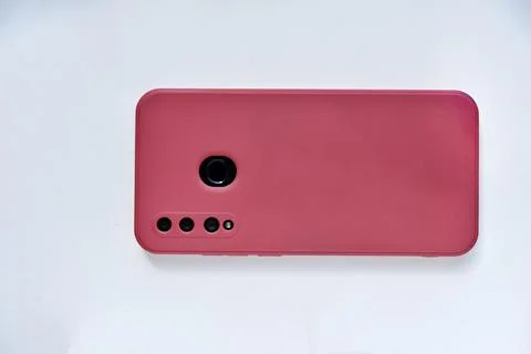 A smartphone in a red case on the back side. Phone camera. Stock Photos