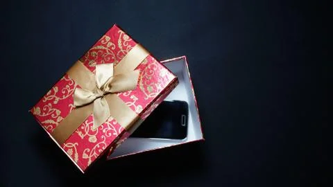 Smartphone In Red Gift Box On Black Background Stock Photos