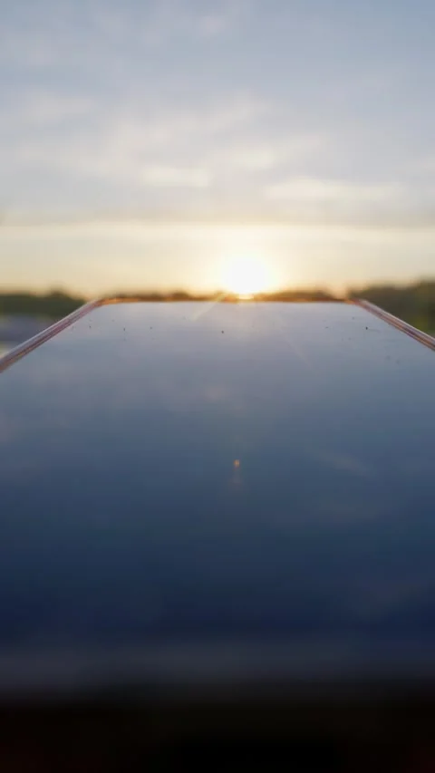 Smartphone Reflecting Golden Hour Sunset Light on Screen in Close Up Stock Footage 345424199