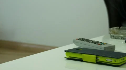 Smartphone Remote Control and Rablet on Table with Coffee and Cigarete Stock Footage 68171203