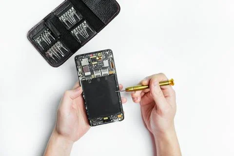 Smartphone repair.Dismantled the smartphone,screwdrivers for disassembling Stock Photos