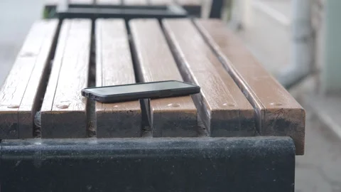 Smartphone resting on wooden table. lost smart phone concept Stock Footage 306275794