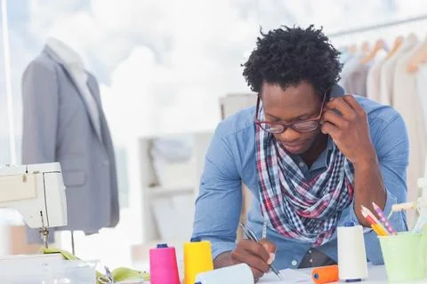 Smartphone ringing while pen is sketching pattern papers on worktable with Stock Photos