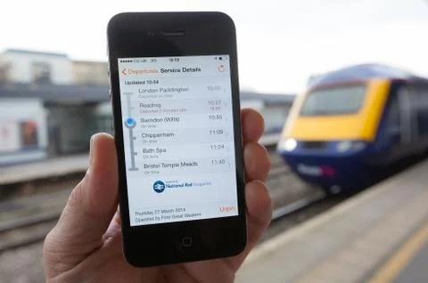 Smartphone running train time app Stock Photos