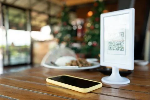 Smartphone to scan QR code for order menu in cafe restaurant with a digital.. Stock Photos