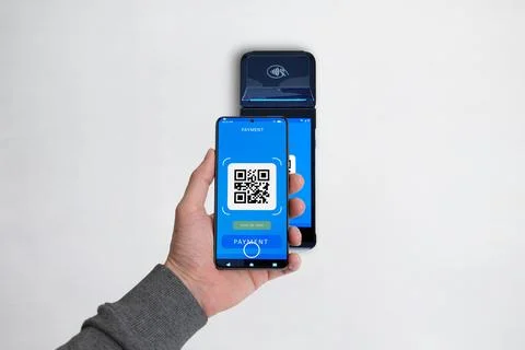 Smartphone scanning a QR code on a POS terminal to complete a payment Stock Photos