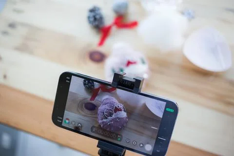 Smartphone screen with Christmas DIY objects on a table. Making Xmas decor at Stock Illustration
