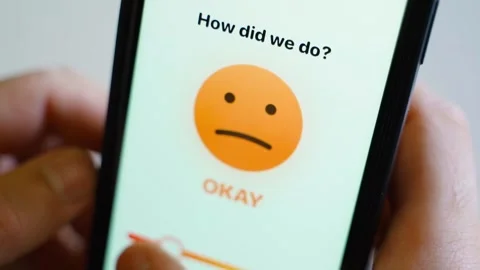 Smartphone screen with customer feedback survey showing angry face and bad Stock Footage 339417668