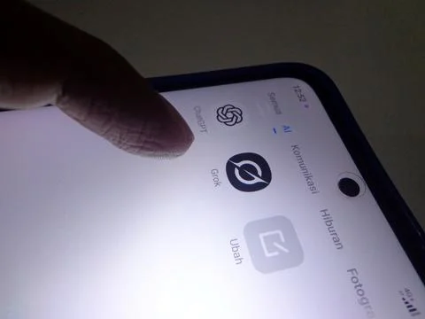 Smartphone screen displaying AI app icons, ChatGPT &amp;amp; Grok Stock Photos