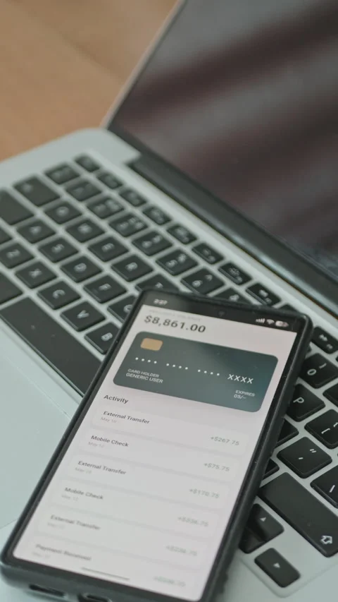 Smartphone screen displaying financial application with rising balance Stock Footage 335525461
