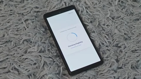 Smartphone screen displaying financial verification loading and instant credit Stock Footage 341569440