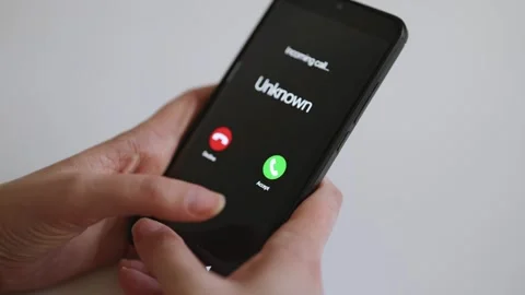 Smartphone screen displaying incoming call from unknown caller. Stock Footage 338998705