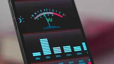 The smartphone screen displays the VU (Volume Unit) meter or level meter Stock Footage 339091527