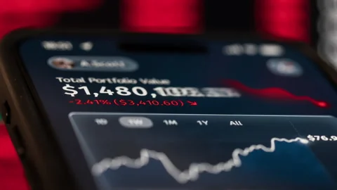 Smartphone screen financial app with declining portfolio value falling charts Stock Footage 328088483