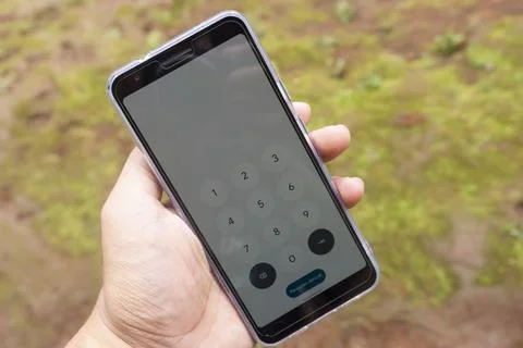 Smartphone Screen Held in Hand With Dial Number Display Stock Photos