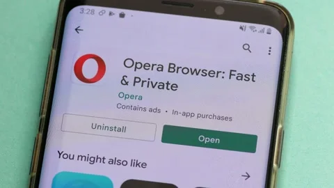 On the smartphone screen, the Opera application logo is installed. Opera browser Stock Footage 171937238
