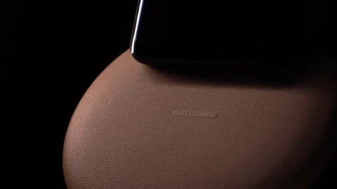 Smartphone Screen over Wireless Charger Showing Animation Fully Charged Battery Stock Footage 128175218