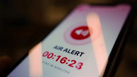 Smartphone screen showing air raid alert with countdown timer close-up Stock Footage 341406183