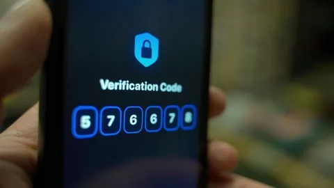 Smartphone screen with verification code close-up in dark room. Entering and Stock Footage 340388644