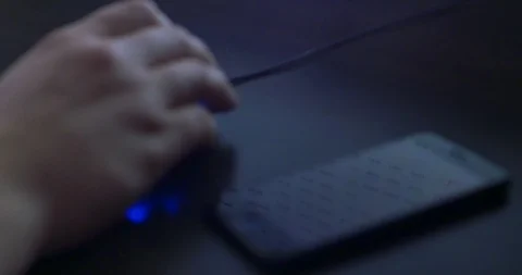 Smartphone with scrolling page reflections on the background. Men's hand using Video stock 97883546