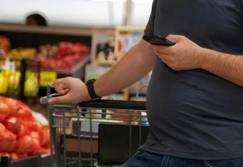 Smartphone in shoppers hand checking, reading, or making sure everything in s Stock Photos