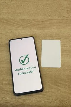 Smartphone Showing Authentication Successful Next to Blank Access Card Stock Photos