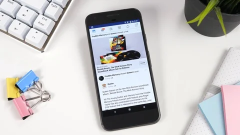 Smartphone Showing the Facebook Feed on Display Screen Stock Footage 88745393