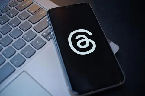 Smartphone Showing Threads App Logo on a Laptop Keyboard Stock Photos