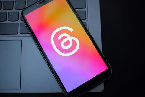 Smartphone Showing Threads App Logo on a Laptop Keyboard Stock Photos