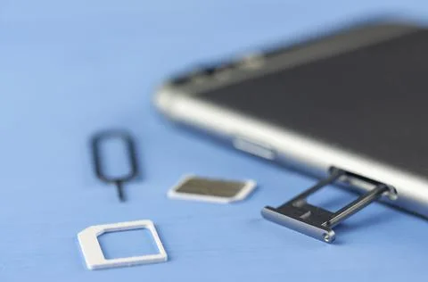 Smartphone with a SIM card key, SIM card, SIM card space is open in Fotos de archivo