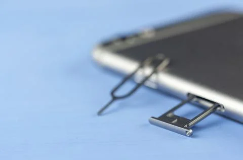 Smartphone with a SIM card key, SIM card, SIM card space is open in Photos