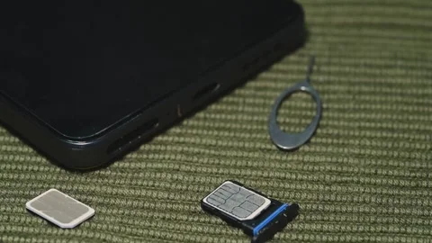 Smartphone SIM Card Replacement with Ejector Pins and Tray Stock Footage 344955379