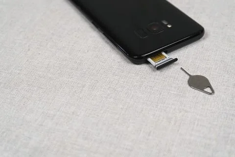 Smartphone SIM card slot and sim ejector tool Stock Photos