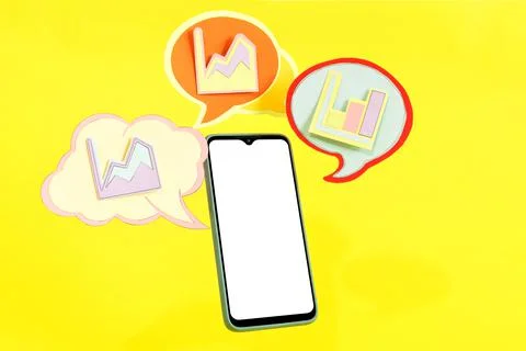 A smartphone with speech bubbles around it showing financial statistics on a  Stock Photos
