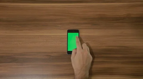 Smartphone Swipe Down hand gesture on the Background of Wooden Table.Vertical Stock Footage 66301663