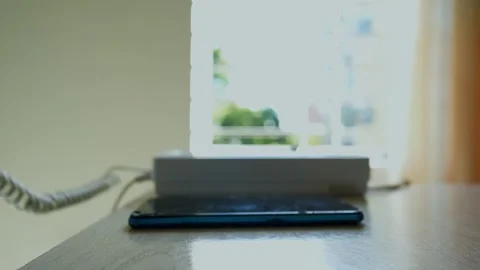 Smartphone on Table with Blurred Window Background Stock Footage 318578033