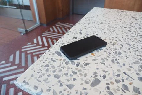 Smartphone on table in cafe during the day. lost phone concept Stock Photos