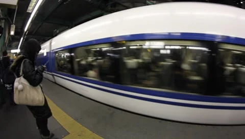 Smartphone texting &amp; express train Tokyo Stock Footage 8629056