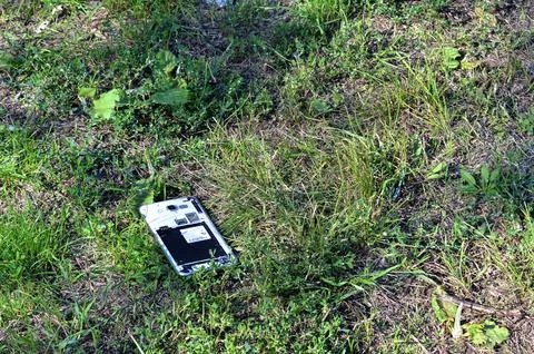Smartphone thrown into the grass Stock Photos