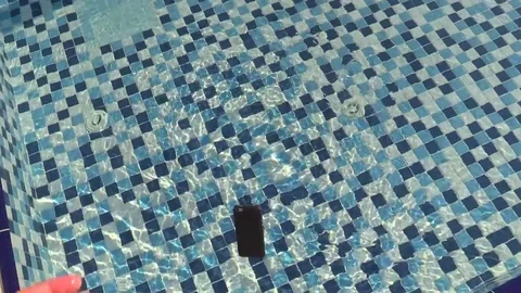 Smartphone is thrown into the pool water. Stock Footage 79161584