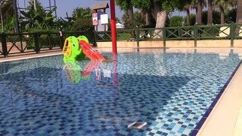 Smartphone is thrown into the pool water. Slow Motion. Stock Footage 78589504