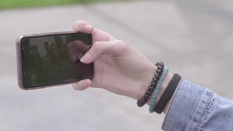 Smartphone touchscreen close up hand taking selfie young smiling friends group Stock Footage 107147805