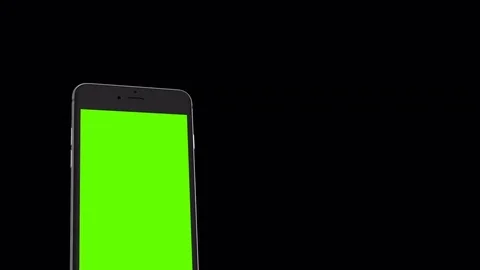 Smartphone turns on on black background. Easy customizable green screen Video stock 70545419