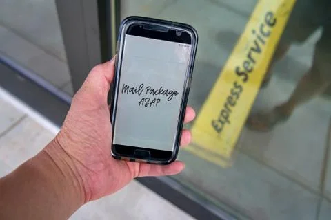 Smartphone with urgent message to mail package immediately right outside the  Stock Photos