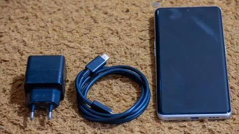 Smartphone with USB-C Charging Cable and Power Adapter Foto stock