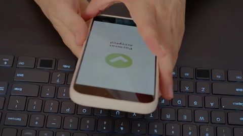 Smartphone used for payment in hands over laptop keyboard Video stock 329230907