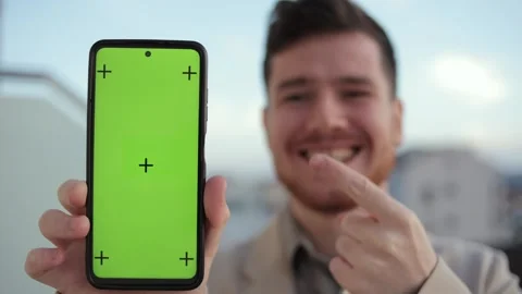 Smartphone vertical orientation with a green screen and tracking dot: a man Stock Footage 247469404