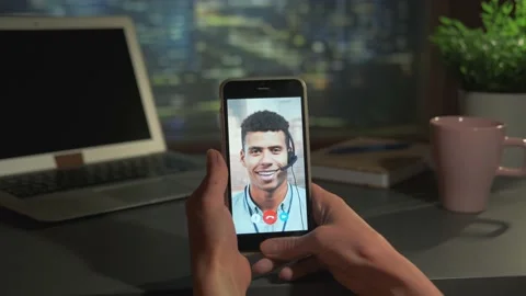 Smartphone video calling with mixed-race man at office. Vertical screen Stock Footage 157600779